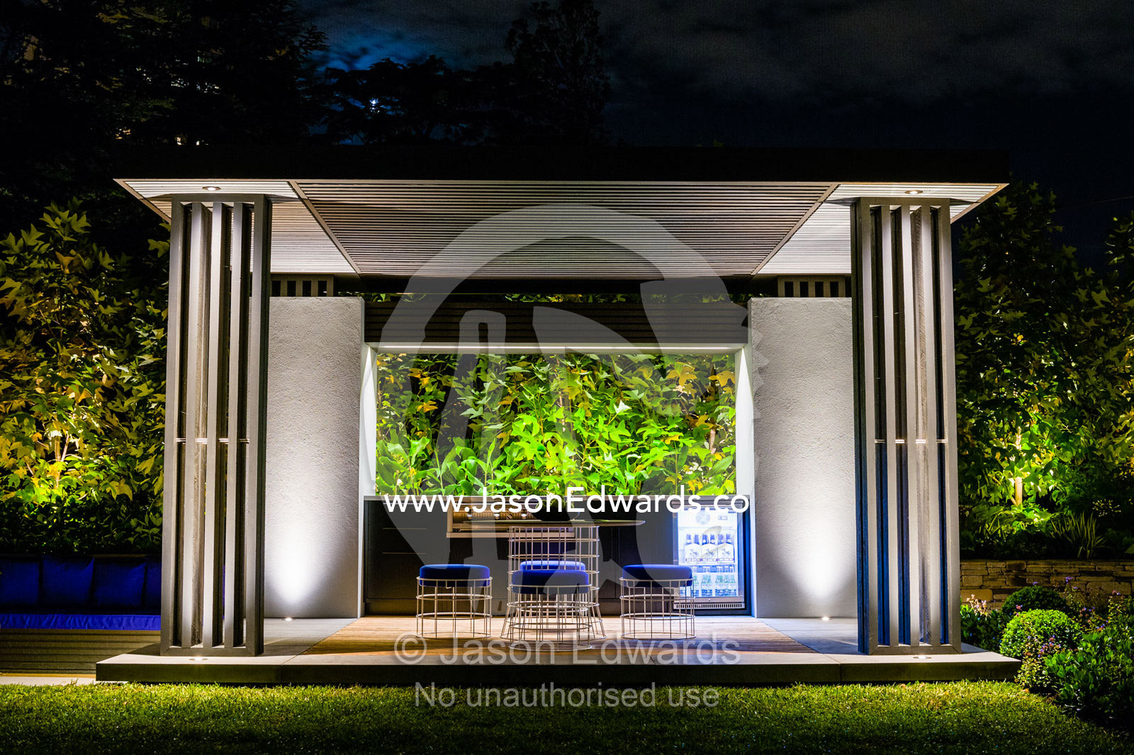 An architecturally designed outdoor patio and garden setting with spotlights at a garden show. Melbourne International Flower and Garden Show, Carlton Gardens, Carlton, Melbourne, Victoria, Australia.