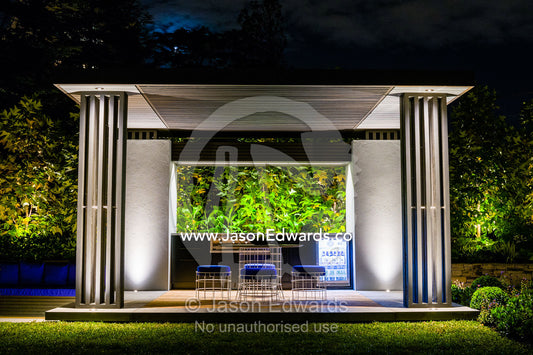 An architecturally designed outdoor patio and garden setting with spotlights at a garden show. Melbourne International Flower and Garden Show, Carlton Gardens, Carlton, Melbourne, Victoria, Australia.