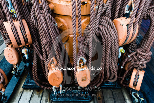 The complicated masts, booms and rigging of an antique sailing ship museum. Polly Woodside, South Wharf Precinct, Yarra River, Melbourne, Victoria, Australia.