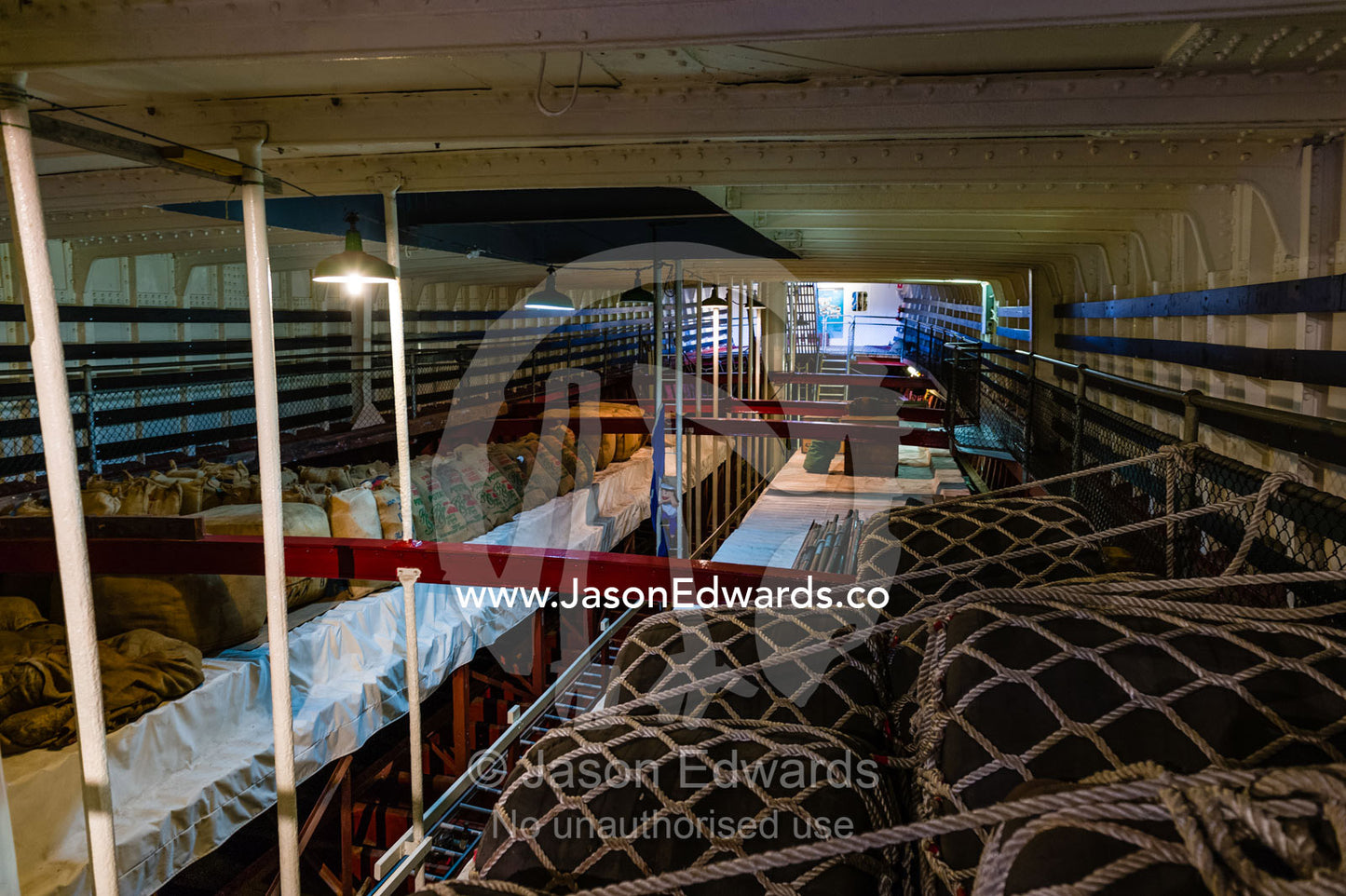 Cargo strapped down with nets in the cargo hold of an antique sailing ship museum. Polly Woodside, South Wharf Precinct, Yarra River, Melbourne, Victoria, Australia.