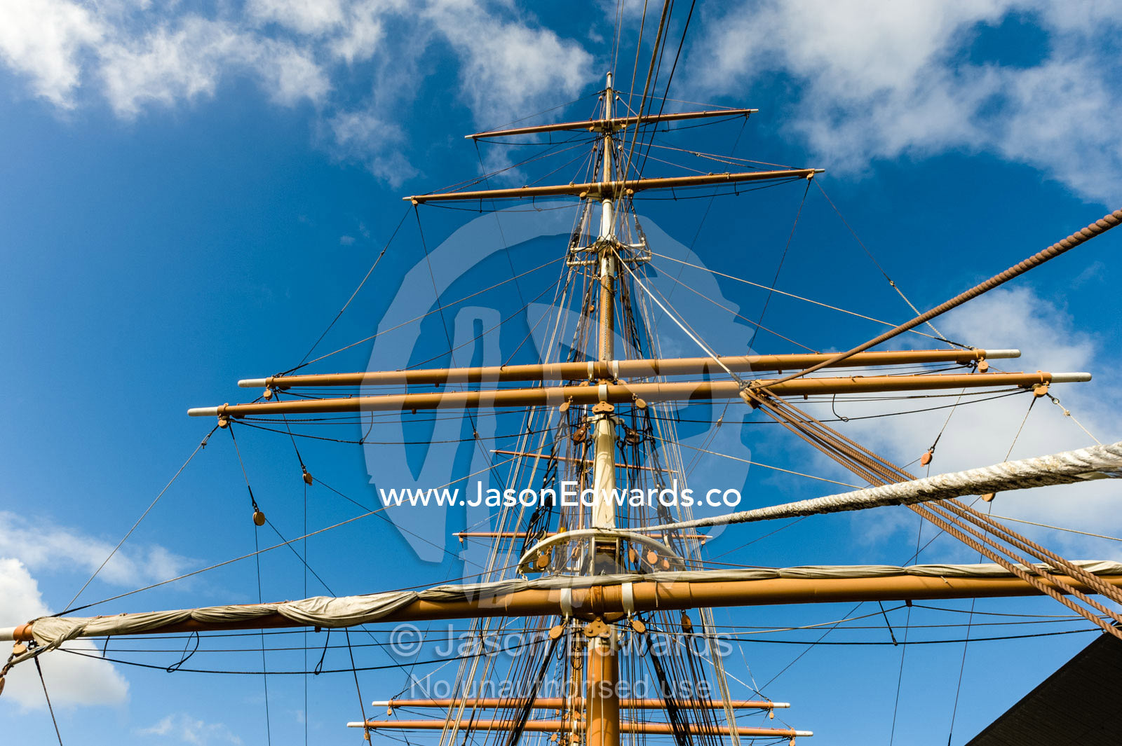 The complicated masts, booms and rigging of an antique sailing ship museum. Polly Woodside, South Wharf Precinct, Yarra River, Melbourne, Victoria, Australia.