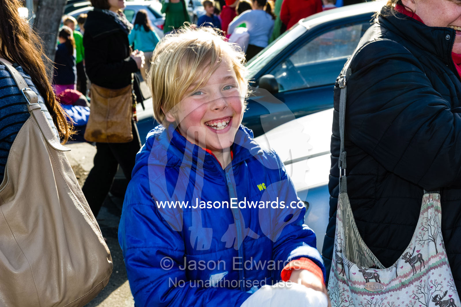 The ecstatic smiling face of a boy seeing his parents after school camp. Carlton North, Melbourne, Victoria, Australia.