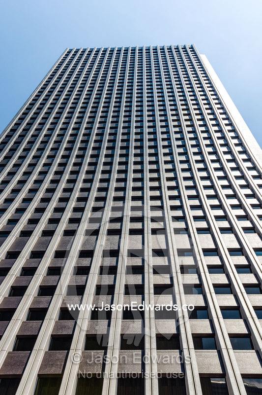 The linear steel and glass facade of an office building in Tokyo. Shinjuku, Tokyo, Japan.
