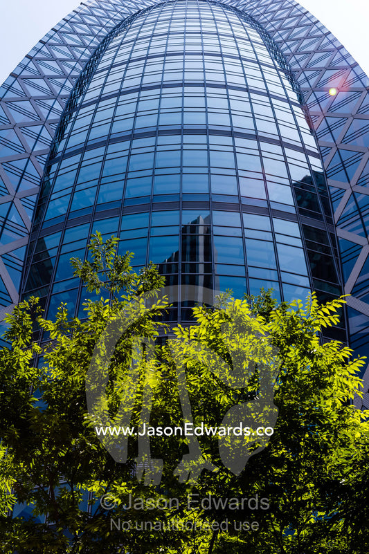 Office buildings reflected in the dome glass facade of a building in Tokyo. Shinjuku, Tokyo, Japan.