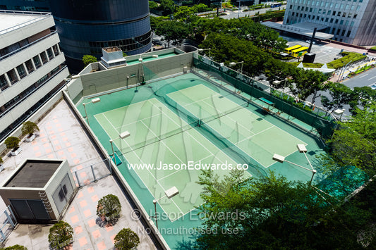 An inner city tennis court in a hotel apartment complex. Shinjuku, Tokyo, Japan.