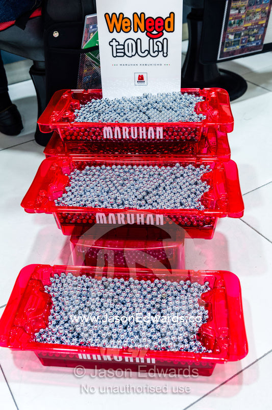 Trays of metal ball bearings used in pachinko gaming venues. Shinjuku Station, Shinjuku, Tokyo, Japan.