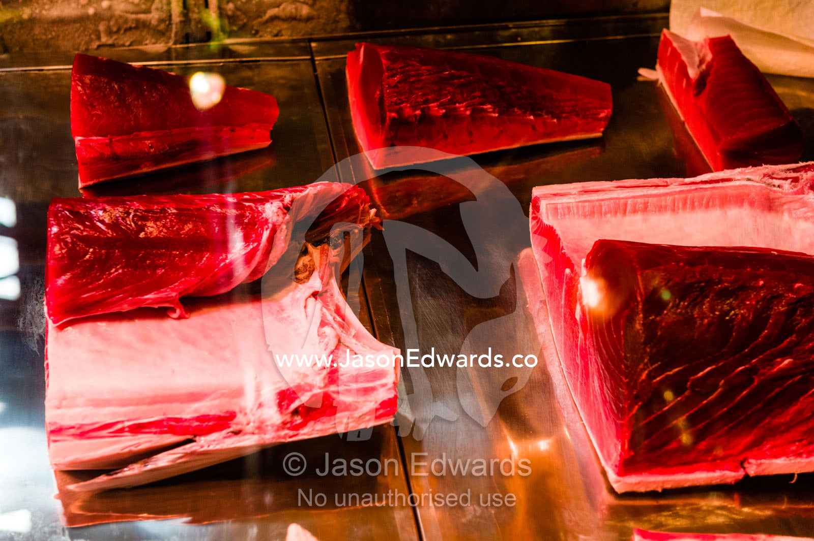 Tuna steaks in a glass display cabinet for sale in a fish market. Tsukiji Market, Tsukiji, Chuo, Tokyo.