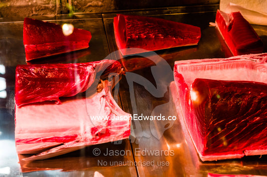 Tuna steaks in a glass display cabinet for sale in a fish market. Tsukiji Market, Tsukiji, Chuo, Tokyo.
