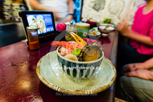 A bowl of crab, abalone, prawn, scallop and wasabi in a fish market cafe. Tsukiji Market, Tsukiji, Chuo, Tokyo.