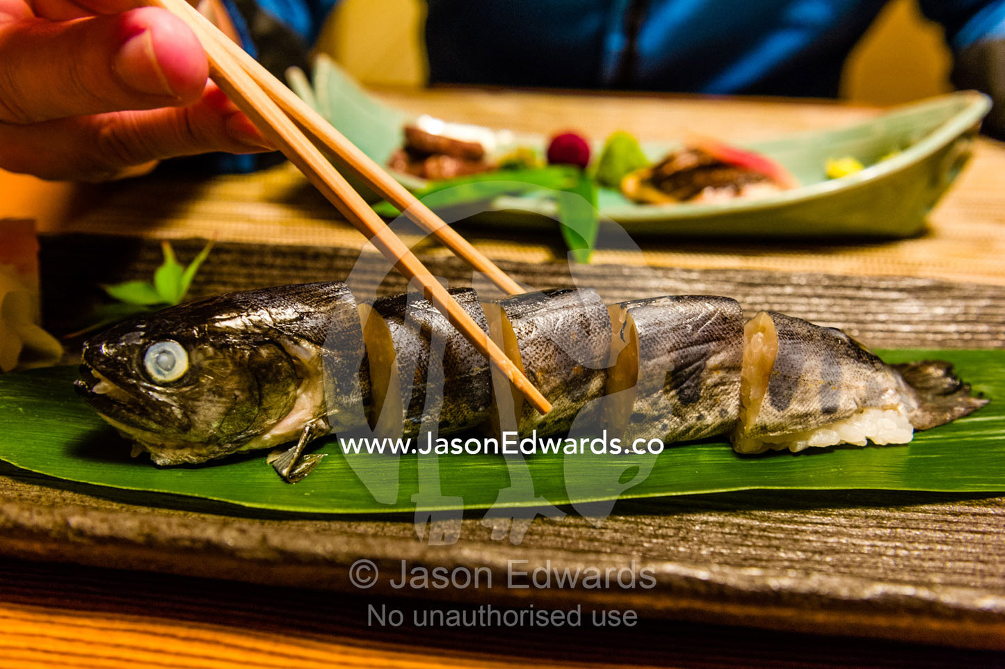 A river fish called Ayu stuffed with rice is called Ayu Mesi served at Kaiseki, a traditional multi-course Japanese dinner. Unryu Onsen, Izu Peninsula, Shizuoka Prefecture, Japan.