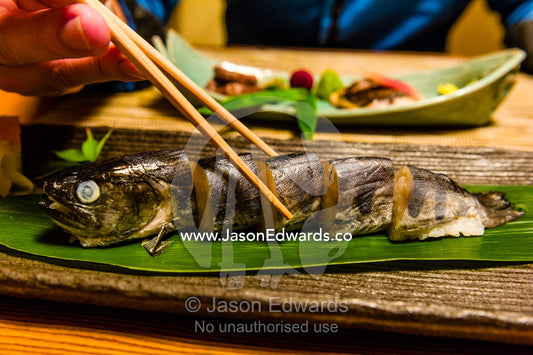A river fish called Ayu stuffed with rice is called Ayu Mesi served at Kaiseki, a traditional multi-course Japanese dinner. Unryu Onsen, Izu Peninsula, Shizuoka Prefecture, Japan.