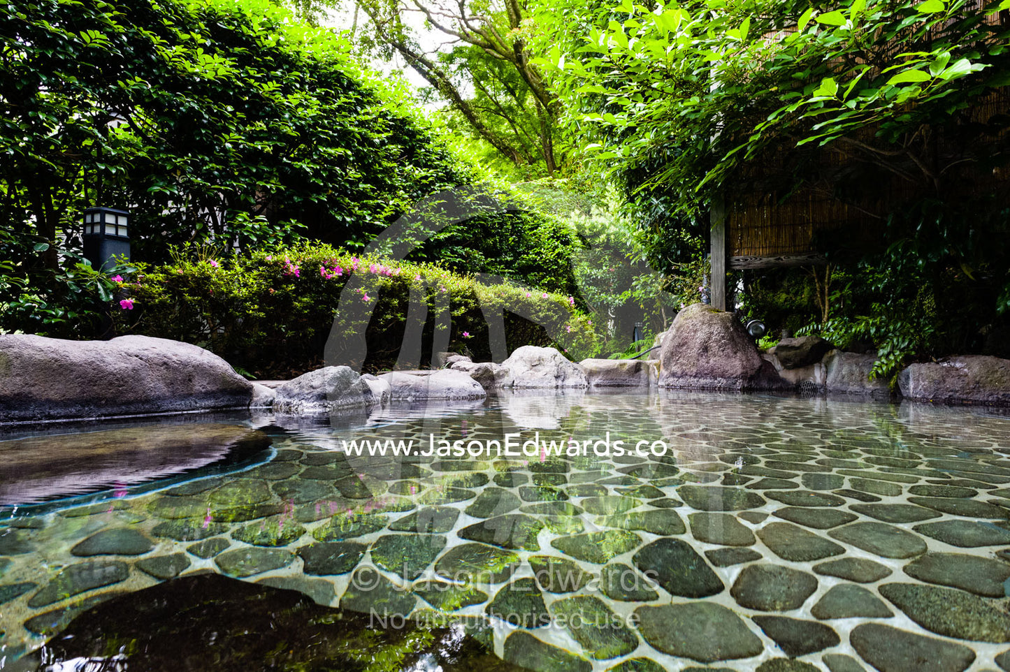 An outdoor hot spring onsen for bathing known as a Rotenburo. Unryu Onsen, Izu Peninsula, Shizuoka Prefecture, Japan.
