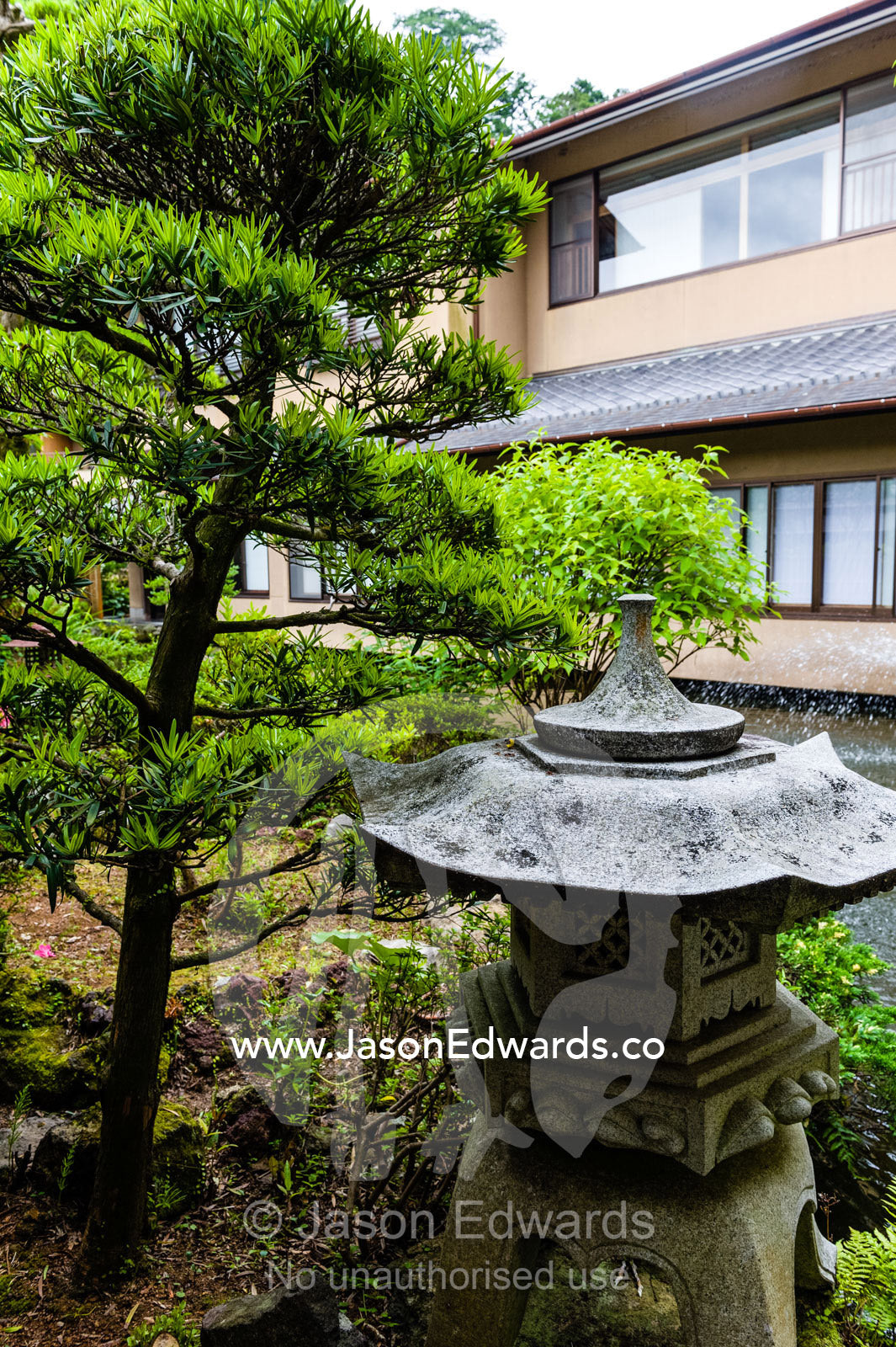 A Japanese pagoda statue in the garden of a ryokan. Unryu Onsen, Izu Peninsula, Shizuoka Prefecture, Japan.