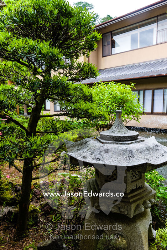 A Japanese pagoda statue in the garden of a ryokan. Unryu Onsen, Izu Peninsula, Shizuoka Prefecture, Japan.