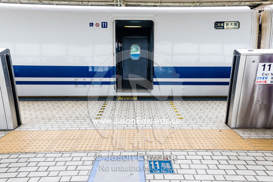 A Skinkansen or Japanese bullet Train at a railway platform. Okayama Station, Okayama, Okayama Prefecture, Japan.