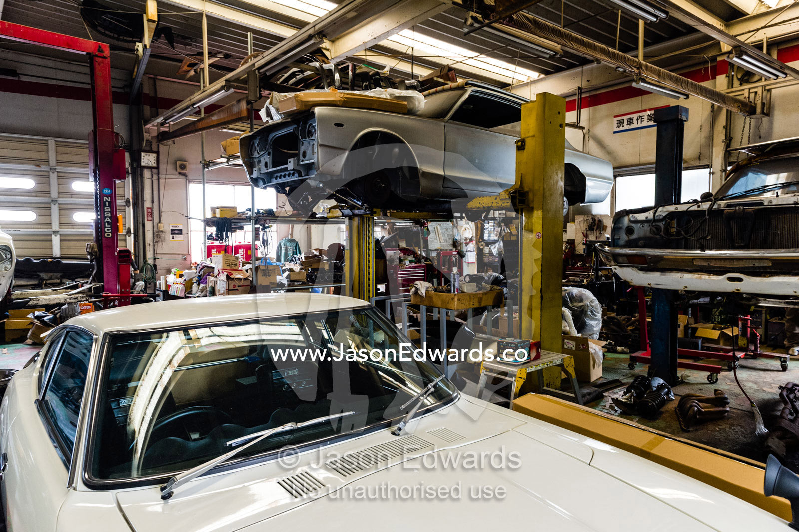 A mechanic workshop with a Datsun Fairlady 432 240Z and KPGC10 Nissan Skyline GTR sports car. Rocky Auto, Nagoya, Chubu Region, Japan.