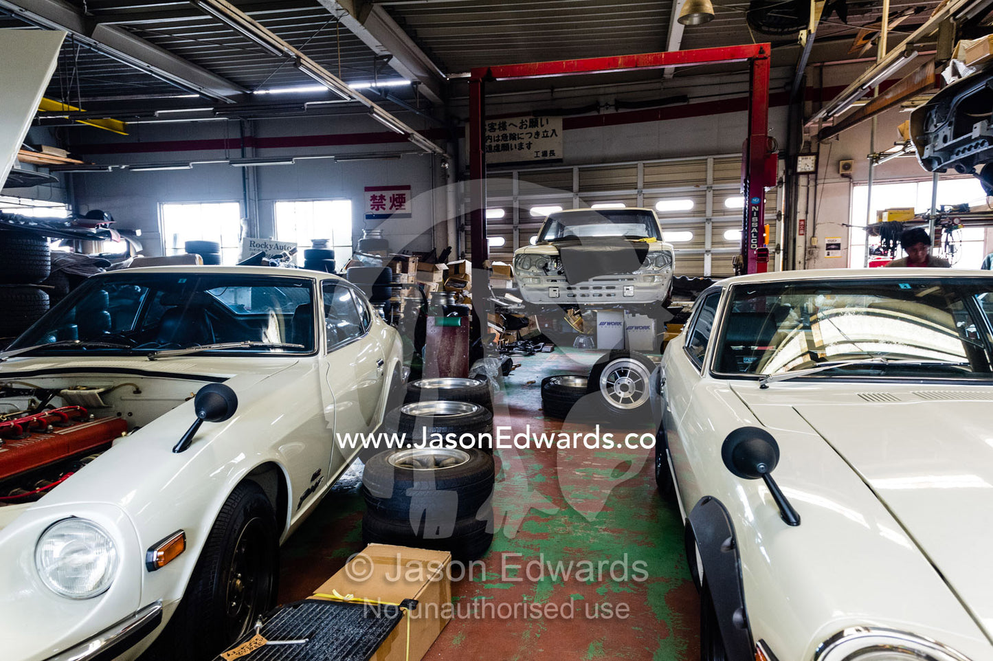 A mechanic workshop with a Datsun Fairlady 432 240Z and KPGC10 Nissan Skyline GTR sports car. Rocky Auto, Nagoya, Chubu Region, Japan.