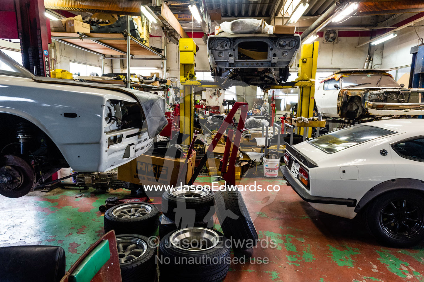 A mechanic workshop with a Datsun Fairlady 432 240Z and KPGC10 Nissan Skyline GTR sports car. Rocky Auto, Nagoya, Chubu Region, Japan.