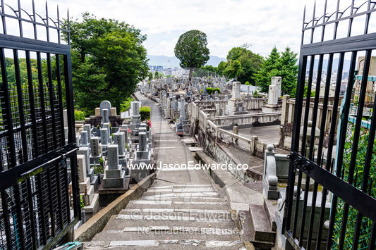 The open gates to a graveyard full of tombstones near a temple in Japan. Otani Honbyo Mausoleum, Kyoto, Japan.