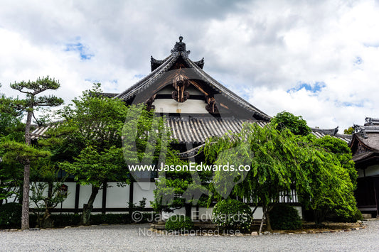 The weathered timber and tree-lined facade of the Myoho-in Temple in Kyoto. Myoho-in Temple, Higashiyama Ward, Kyoto, Kyoto Prefecture, Japan.