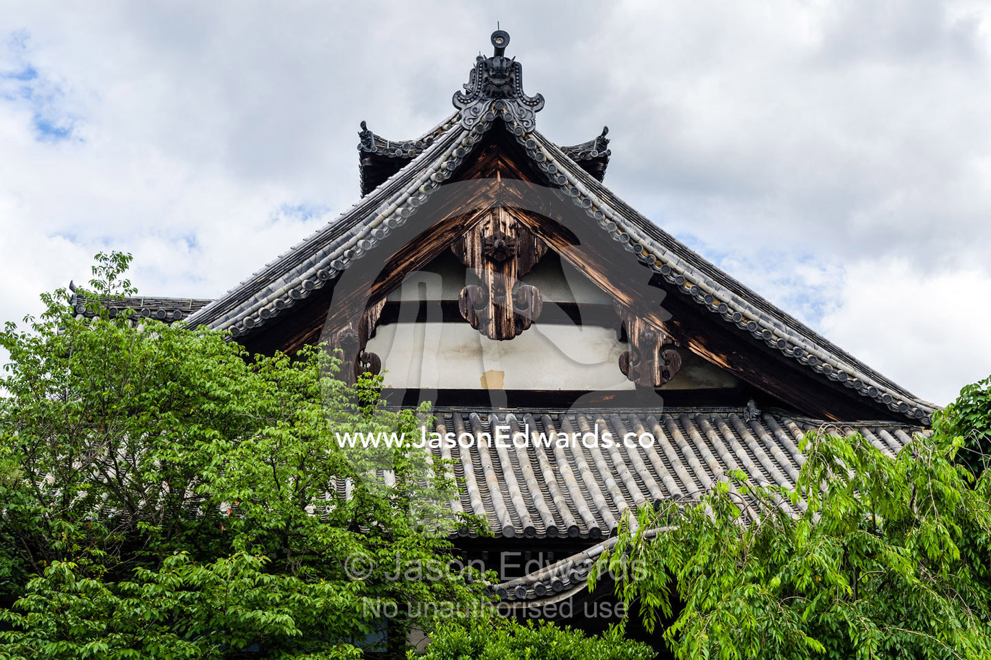 The weathered timber and tree-lined facade of the Myoho-in Temple in Kyoto. Myoho-in Temple, Higashiyama Ward, Kyoto, Kyoto Prefecture, Japan.