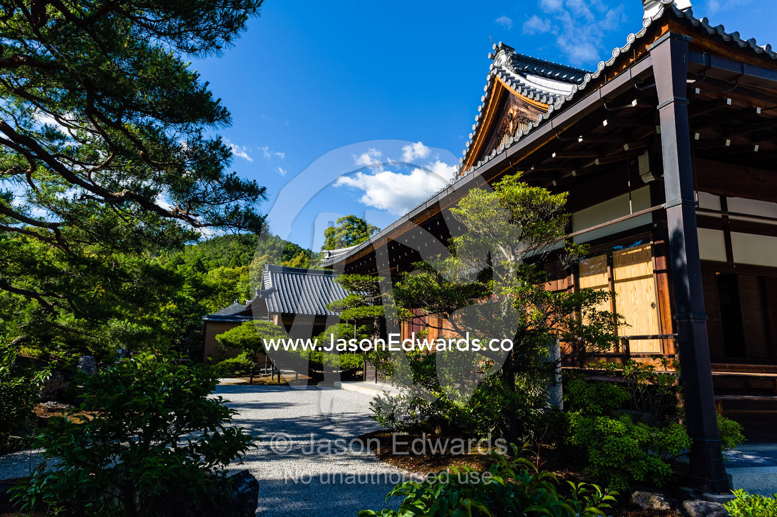 A path between ancient temples near the Temple of the Golden Pavilion. Temple of the Golden Pavilion, Kinkaku-ji, Kyoto, Japan.