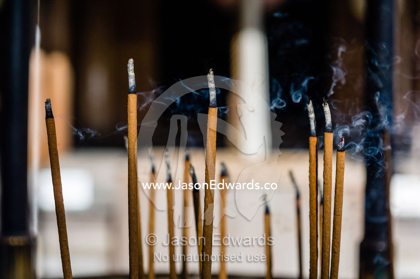 Incense sticks burning in a buddhist temple. Temple of the Golden Pavilion, Kinkaku-ji, Kyoto, Japan.