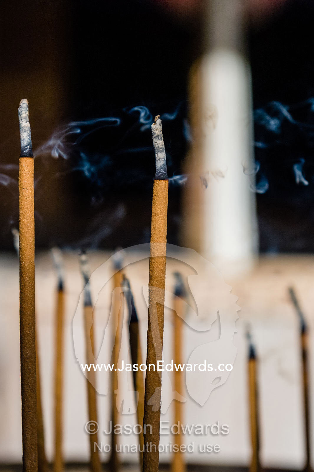 Incense sticks burning in a buddhist temple. Temple of the Golden Pavilion, Kinkaku-ji, Kyoto, Japan.