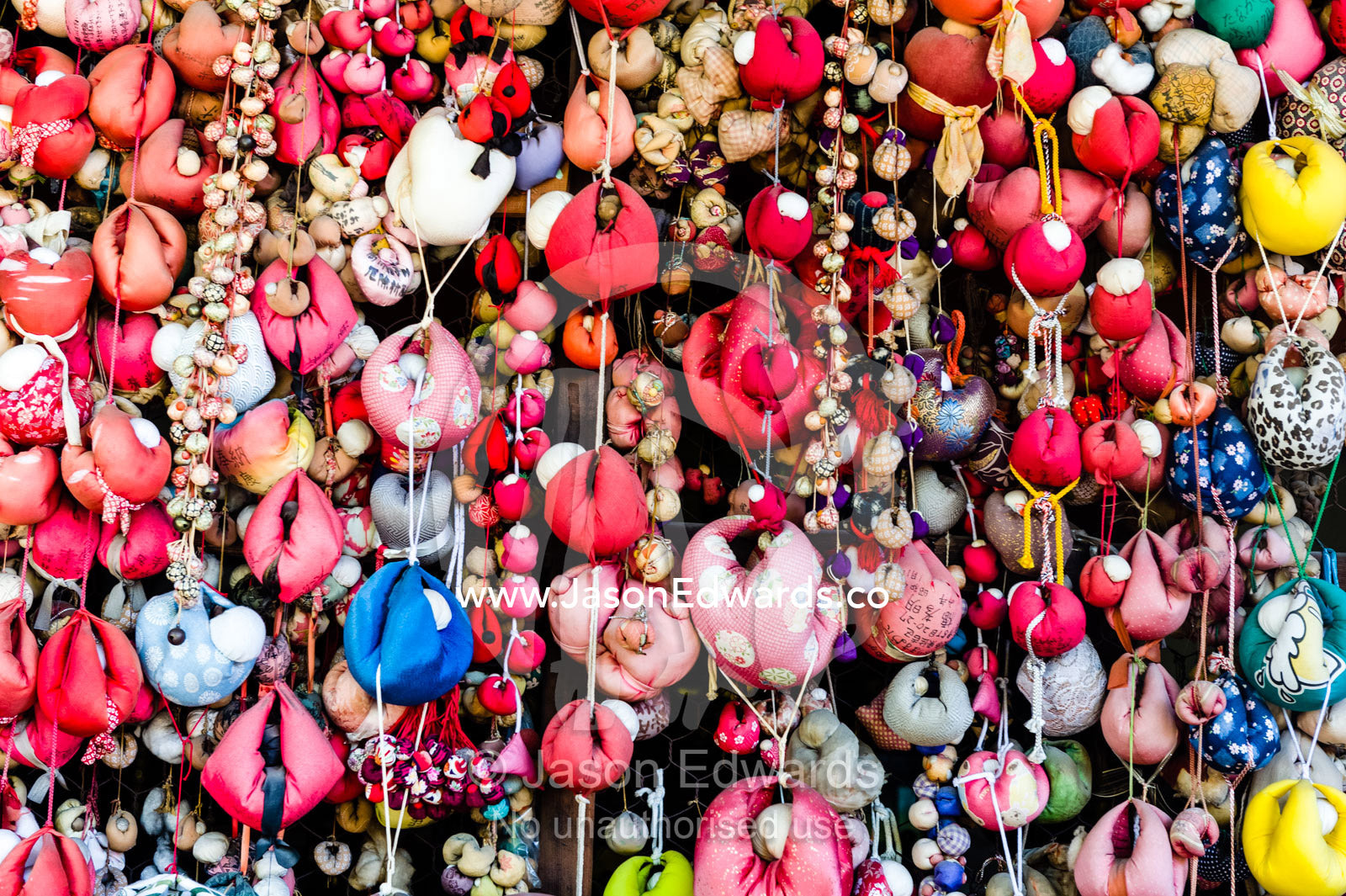 Kukurizaru are the round, ball shaped talismans made of cloth, representing the good faith monkeys. Yasaka Koshin-do Temple, Higashiyama, Kyoto, Japan.
