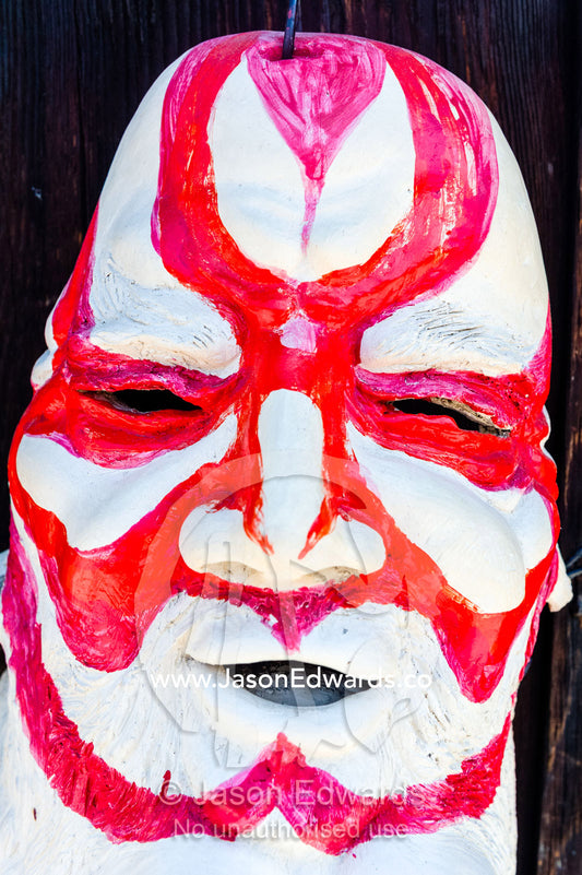 A red and white striped artist clay sculpture of a mans face. Yasaka Pagoda, Hokanji Temple, Higashiyama, Kyoto, Japan.