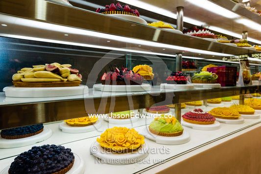 A glass display case with decorated cakes in a railway station in Japan. Hiroshima, Honshu Island, Japan.