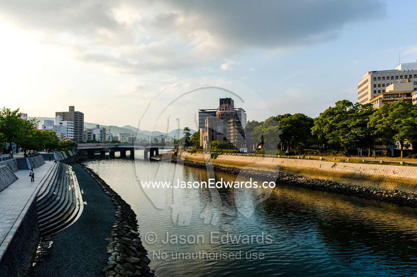 The ruin of the Hiroshima Prefectural Industrial Promotion Hall known as the Atomic Bomb Dome or Genbaku Dōmu. Aioi Bridge, Ota River, Hiroshima Peace Memorial Park, Hiroshima, Honshu Island, Japan.