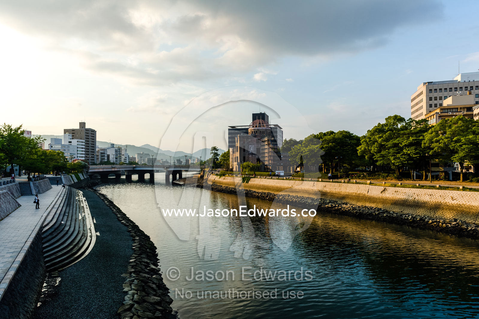 The ruin of the Hiroshima Prefectural Industrial Promotion Hall known as the Atomic Bomb Dome or Genbaku Dōmu. Aioi Bridge, Ota River, Hiroshima Peace Memorial Park, Hiroshima, Honshu Island, Japan.