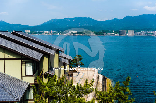 The view over the rooftops of houses to a small bay in Japan. Hiroshima Bay, Miyajima, Itsukushima Island, Inland Sea of Japan, Hiroshima Bay, Japan.