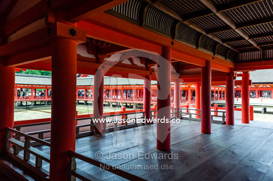 The red columns and boardwalks of the Itsukushima Shrine walk out over the ocean. Itsukushima Shrine, Miyajima, Itsukushima Island, Inland Sea of Japan, Hiroshima Bay, Japan.