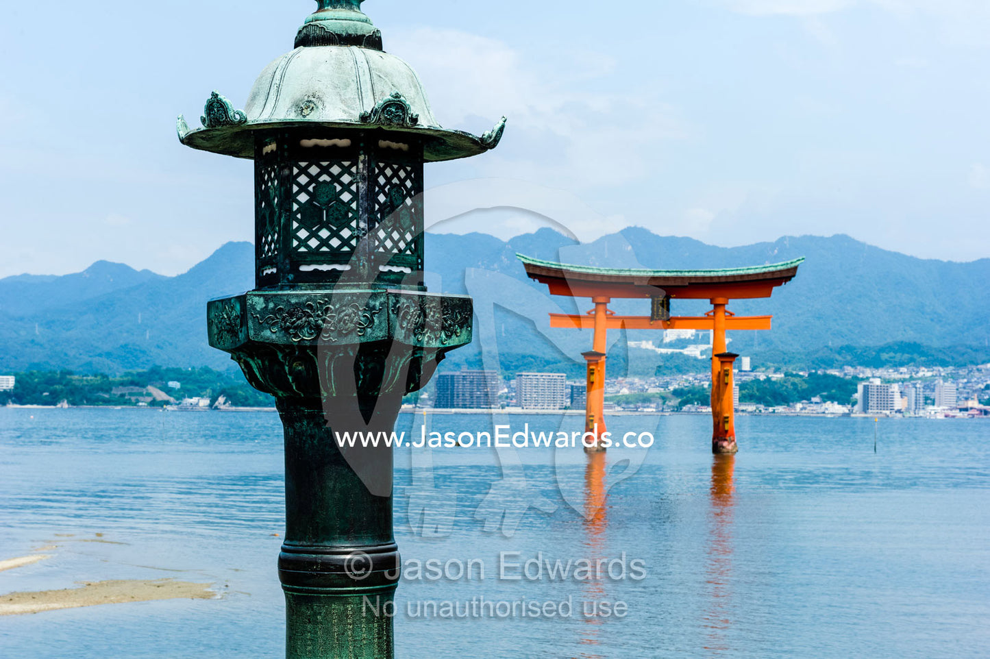 A Japanese temple lantern at the famous floating torii gate at Itsukushima Shrine. Itsukushima Shrine, Miyajima, Itsukushima Island, Inland Sea of Japan, Hiroshima Bay, Japan.