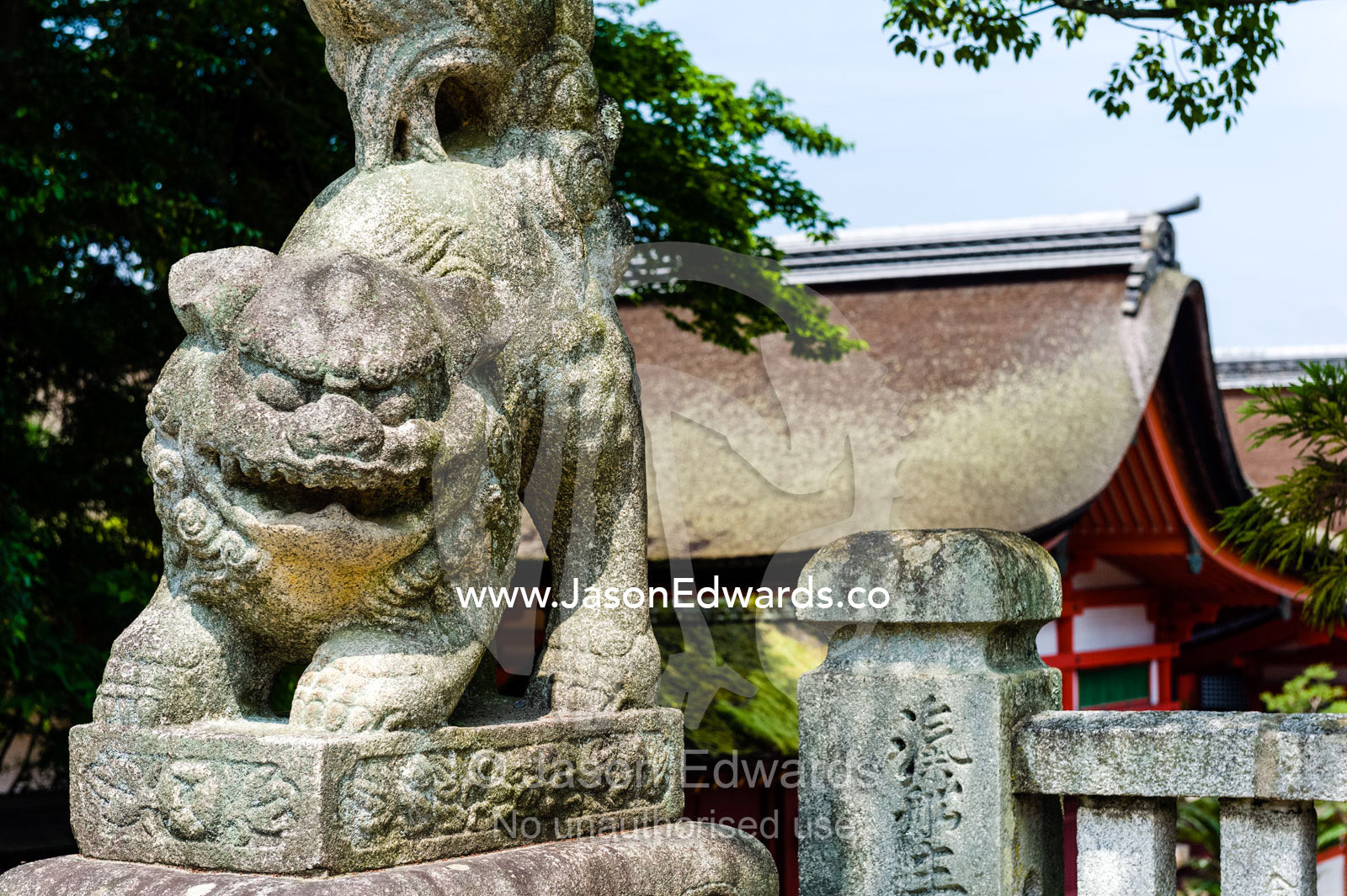 A Komainu lion statue guarding a shrine from evil sprits. Itsukushima Shrine, Miyajima, Itsukushima Island, Inland Sea of Japan, Hiroshima Bay, Japan.