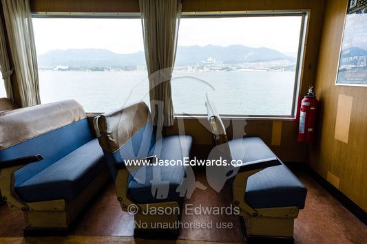 Empty seats on a ferry running between an island and the mainland. Miyajima, Itsukushima Island, Inland Sea of Japan, Hiroshima Bay, Japan.