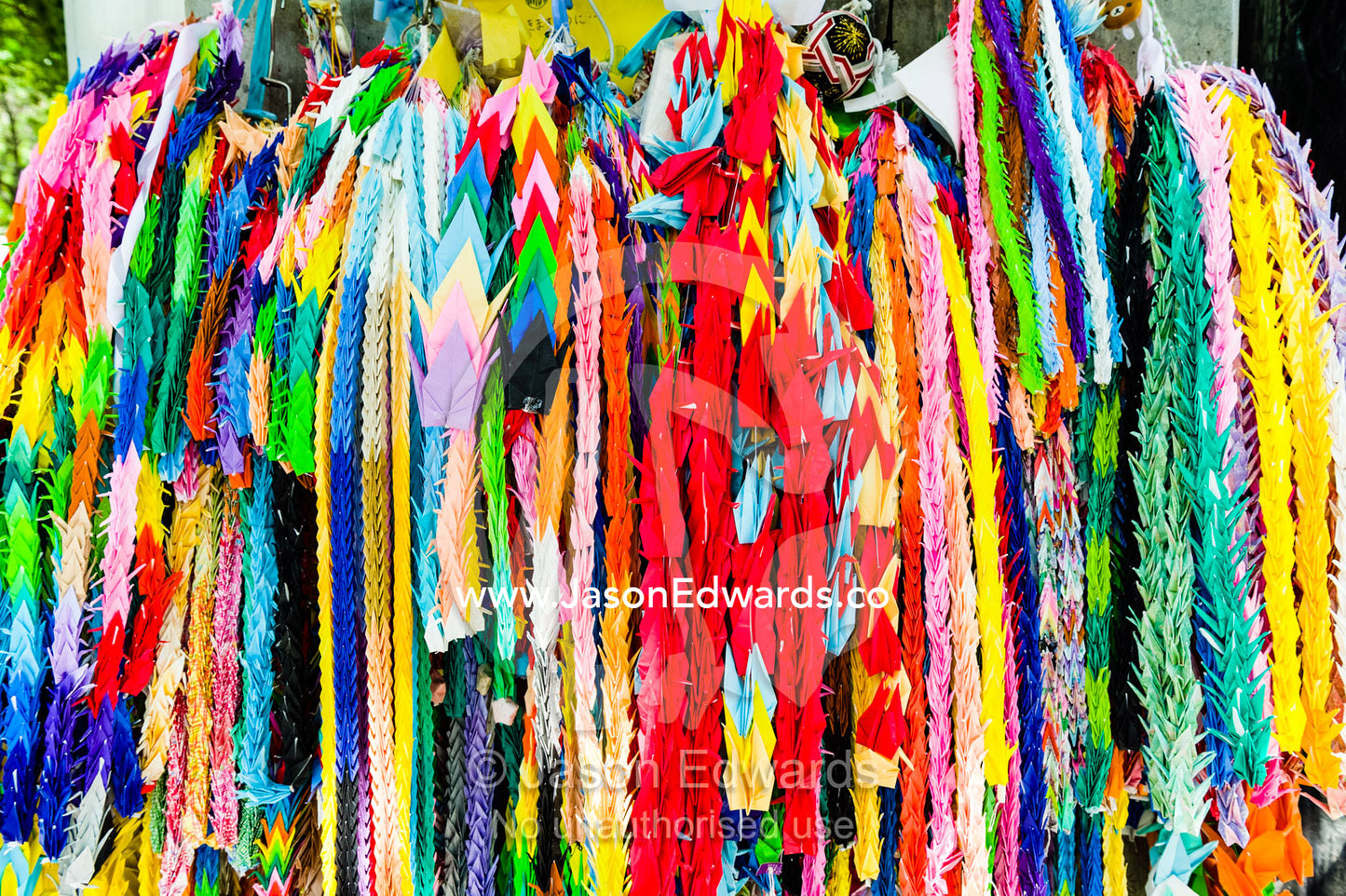 Thousand Origami Cranes is a group of one thousand origami paper cranes held together by strings. Hiroshima Peace Memorial Park, Hiroshima, Honshu Island, Japan.