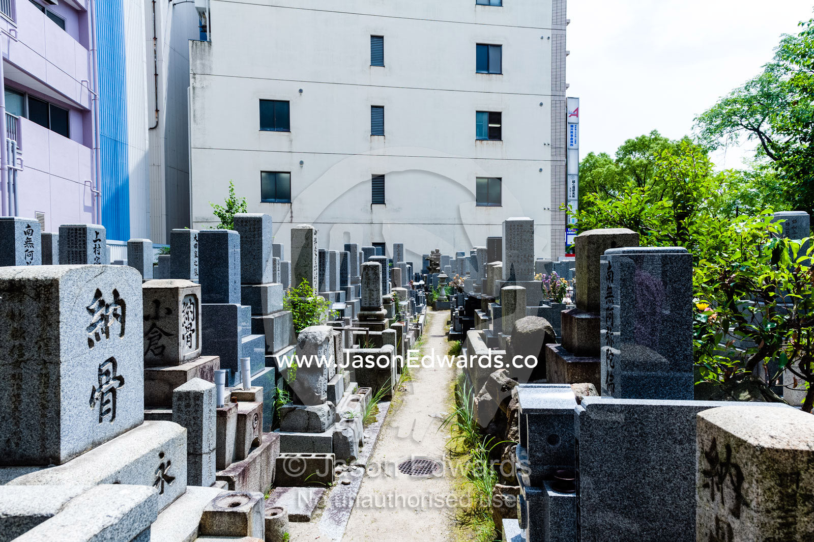 A small cemetery adjacent to the Atomic Bomb Dome where the stone on the tombstones was fused by the blast. Hiroshima Peace Memorial Park, Hiroshima, Honshu Island, Japan.