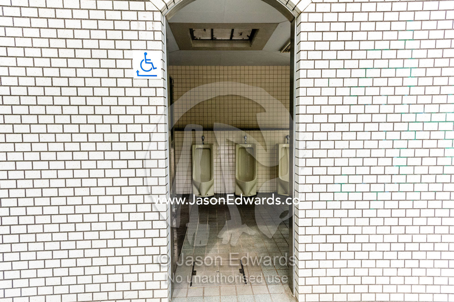 The open doorway to a public urinal in Japan. Hiroshima Peace Memorial Park, Hiroshima, Honshu Island, Japan.