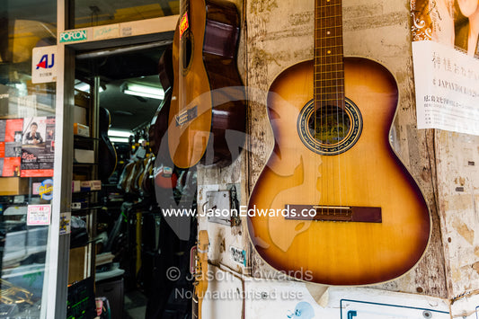 Acoustic guitars for sale in a Japanese music store. Hiroshima, Honshu Island, Japan.