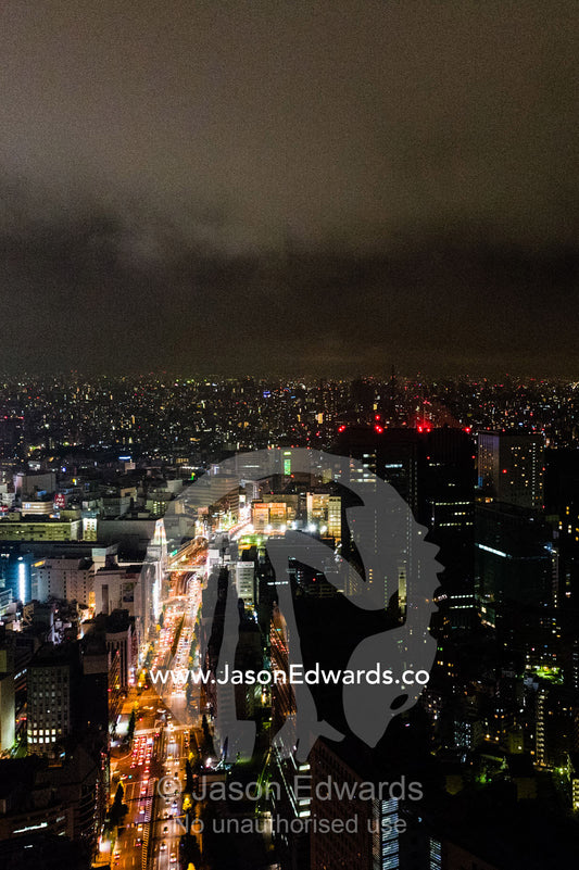 Traffic congestion on the streets beneath the Tokyo city skyline at night. Park Hyatt, Tokyo, Japan.