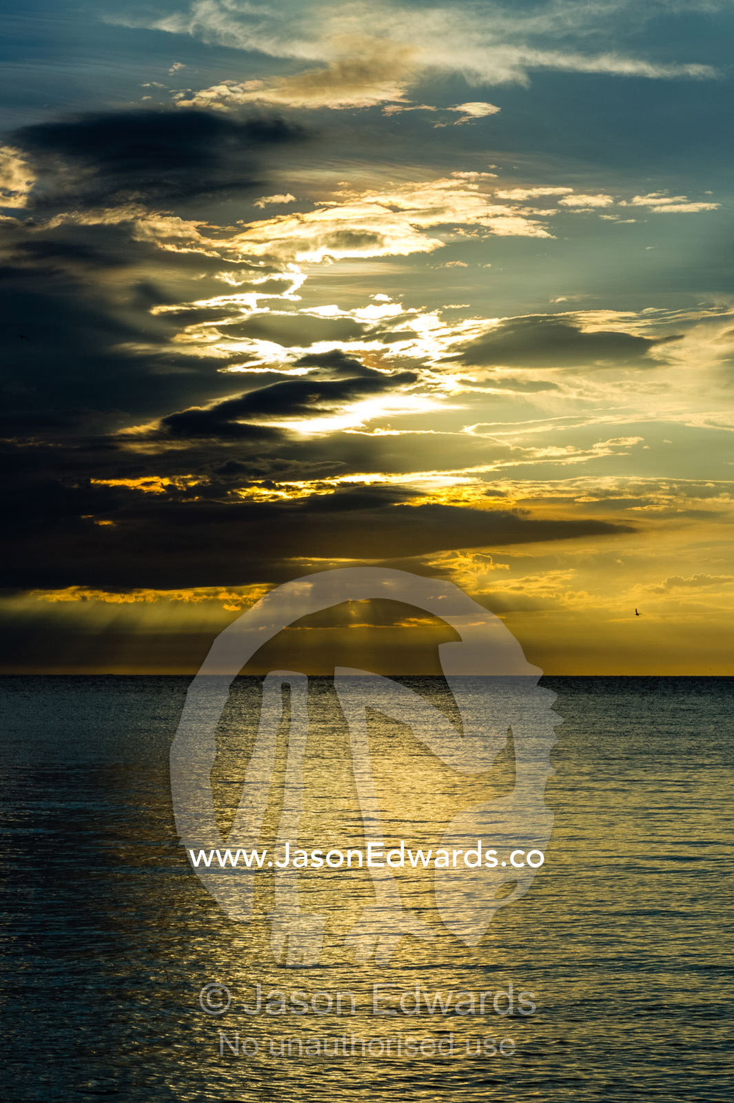A sunset storm reflected in the ocean surface. Research Beach, Heron Island, Great Barrier Reef, Queensland, Australia.