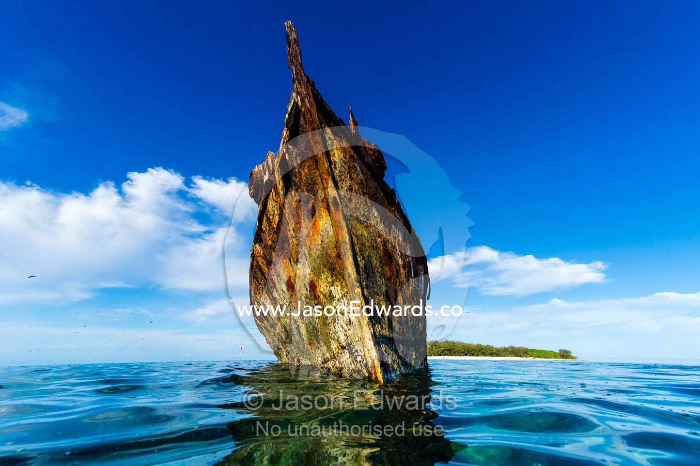 The rusting shipwreck of the HMAS Protector a large flat-iron gunboat trapped on a coral reef. Wreck Beach, Heron Island, Great Barrier Reef, Queensland, Australia.