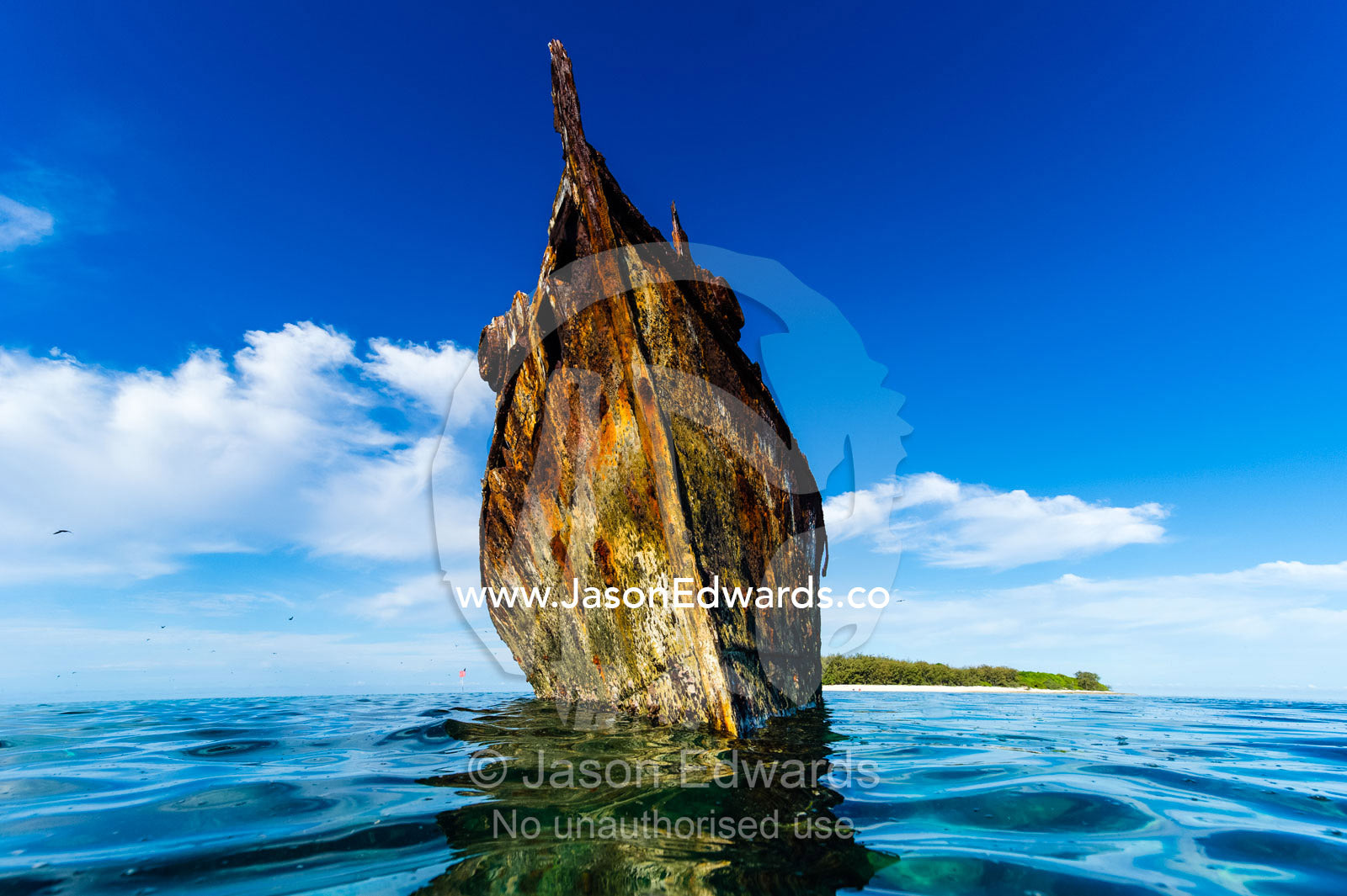 The rusting shipwreck of the HMAS Protector a large flat-iron gunboat trapped on a coral reef. Wreck Beach, Heron Island, Great Barrier Reef, Queensland, Australia.