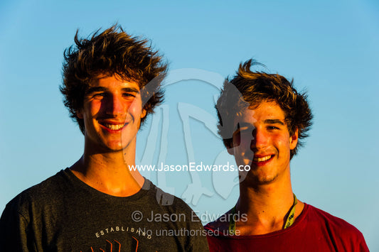 Two smiling twin teenage brothers on a beach at dawn. Heron Island, Great Barrier Reef, Queensland, Australia.