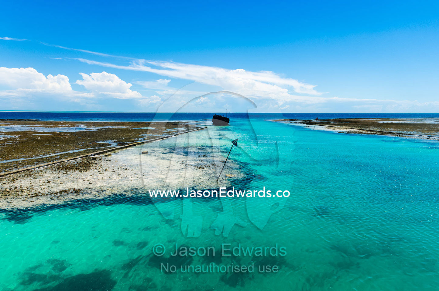 A manmade channel cut through a coral reef to allow boats to access a tropical island. Heron Island Harbour, Heron Island, Great Barrier Reef, Queensland, Australia.