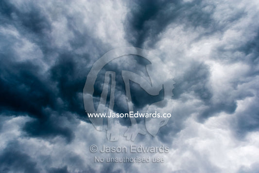 The billowing clouds of a menacing tropical rainstorm darkens the sky. Gladstone, Queensland, Australia.