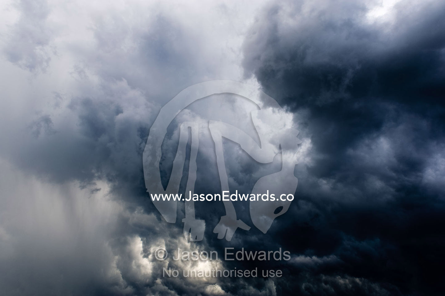 The billowing clouds of a menacing tropical rainstorm darkens the sky. Gladstone, Queensland, Australia.